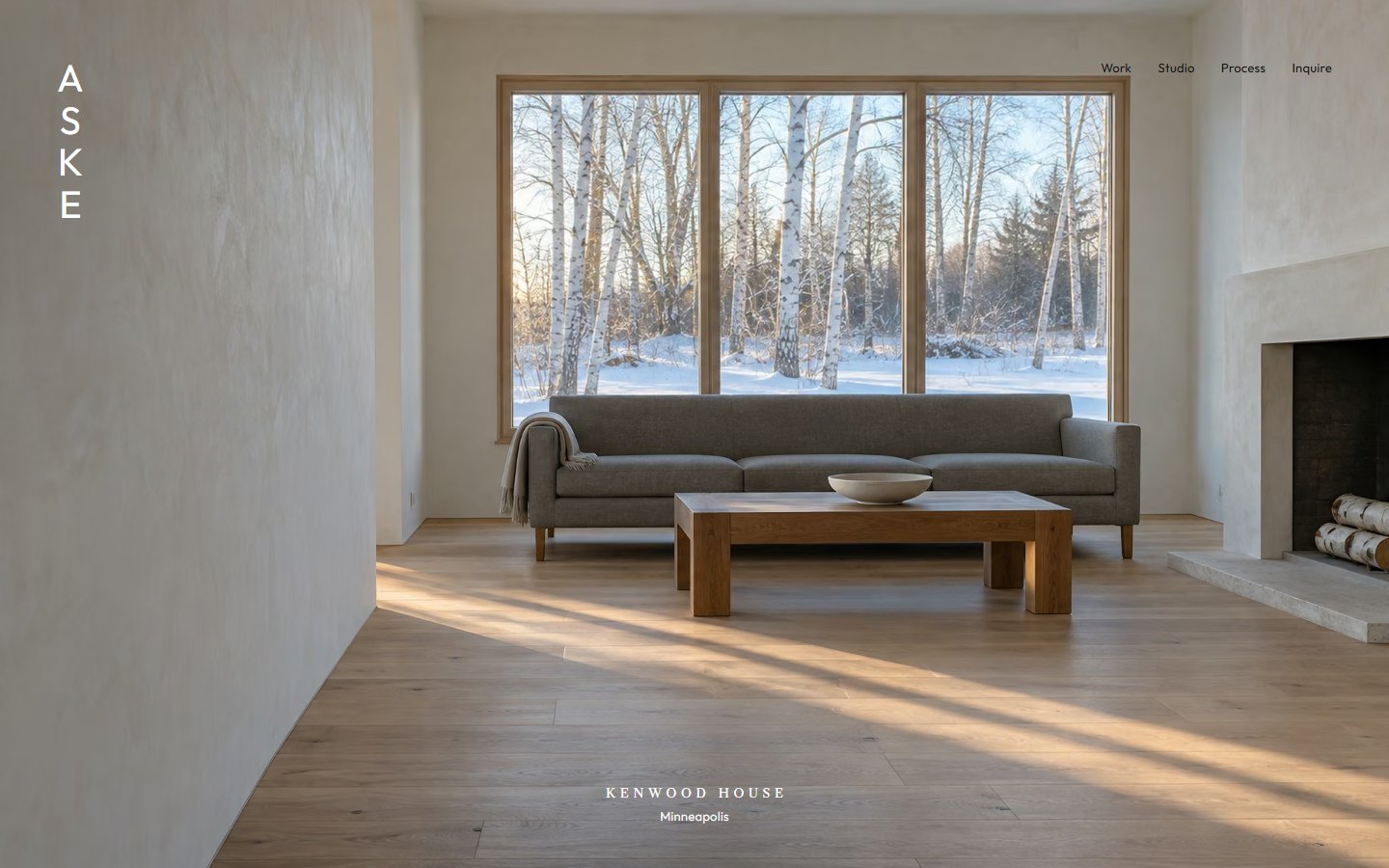 The Aske homepage: a pale living room with a wall of windows onto birches in snow, the name set down the left edge.